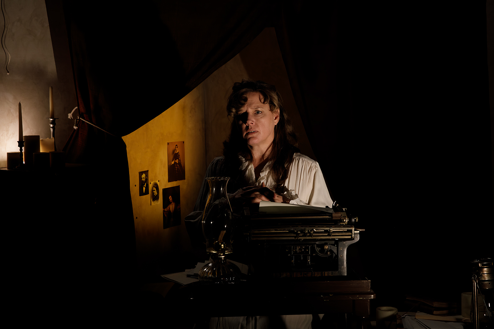 Ida Craddock at typewriter in dark in scene from film